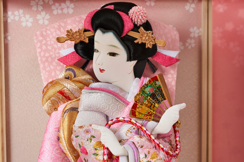 A Japanese lady who wearing white kimono and holding a gold fan on a three-dimensional decorations affixed to wood panels